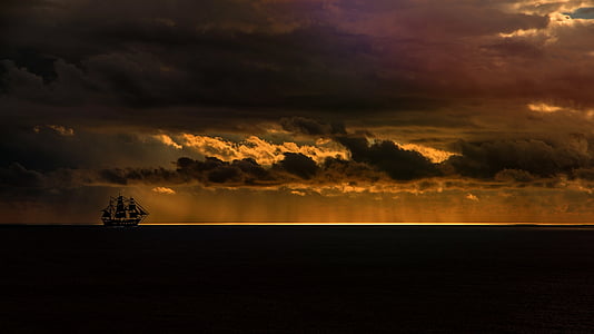 silhouette photography of white sailing ship on sea