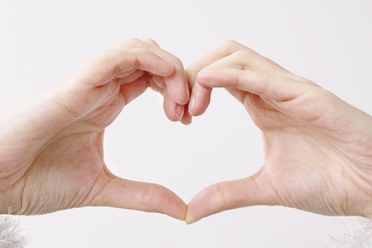 person doing heart gesture