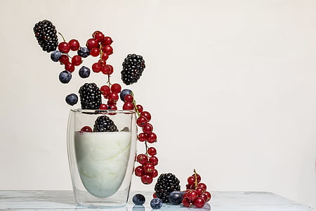 assorted berries in clear drinking glass
