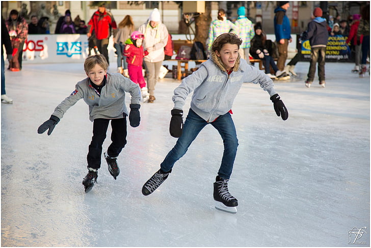 two boys playing ice skates