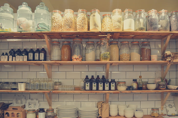 jars on rack above plates and bowls