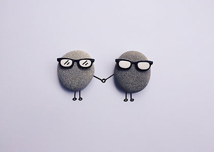 two gray wall decor with sunglasses