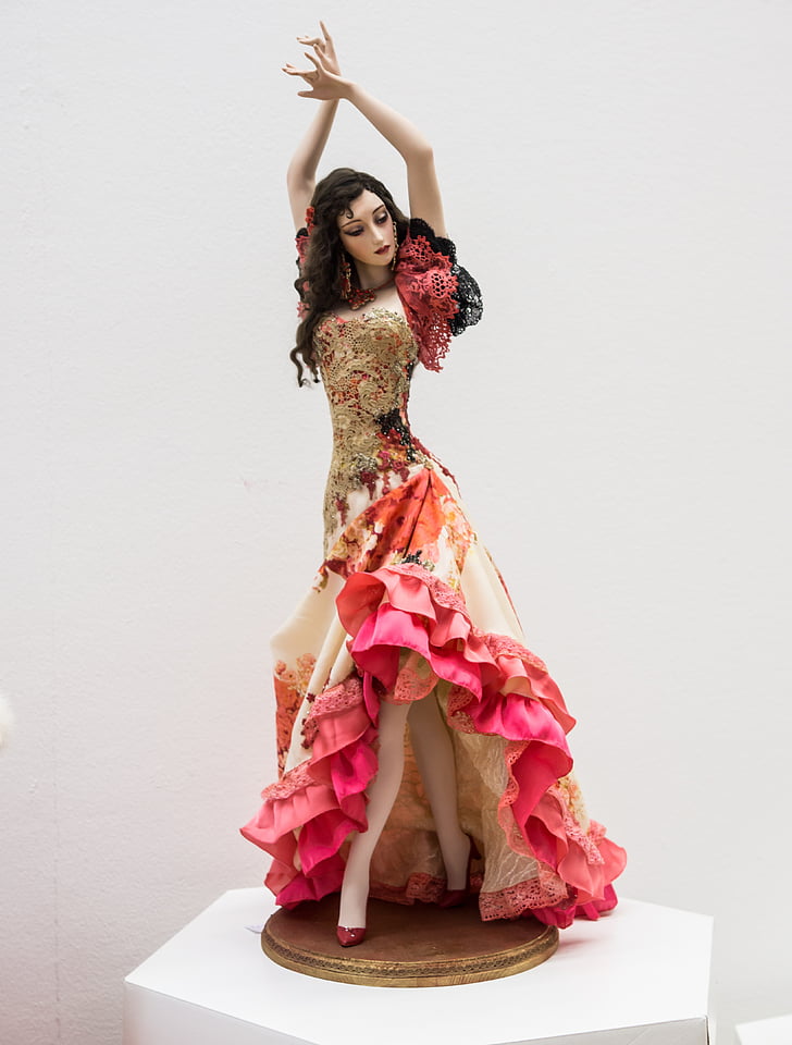woman in red and brown floral ruffle dress figurine