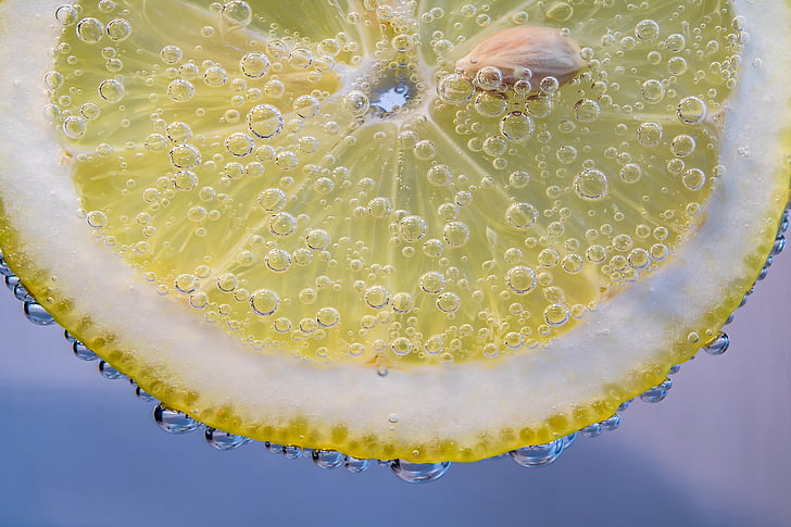 macro photography of sliced lemon in carbonated drink