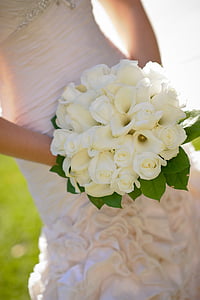 woman holding white flower bouquet