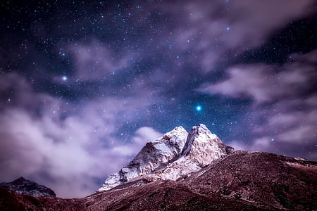 snowy mountain during night time