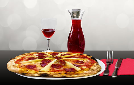 pizza on plate with wine glass