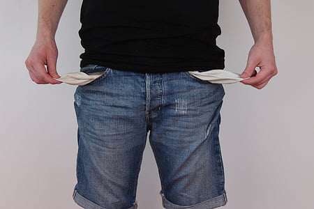 person wearing blue denim shorts showing empty pockets