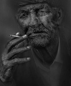 grayscale photo of man smoking