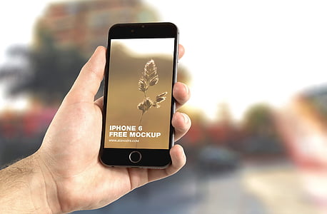 person holding iPhone with iPhone 6 free mockup display