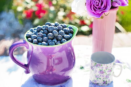 pitcher of blueberries near mug