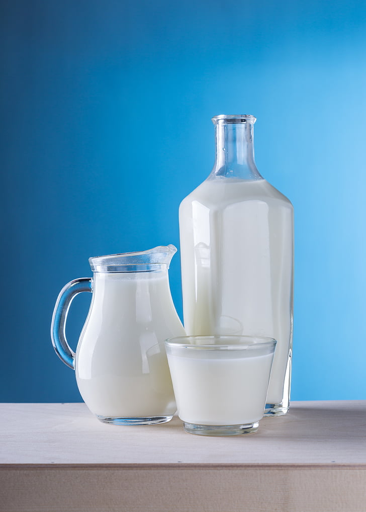 clear glass pitcher filled with milk
