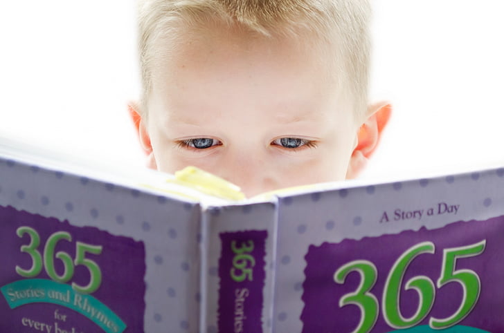 boy holding a 365 story book