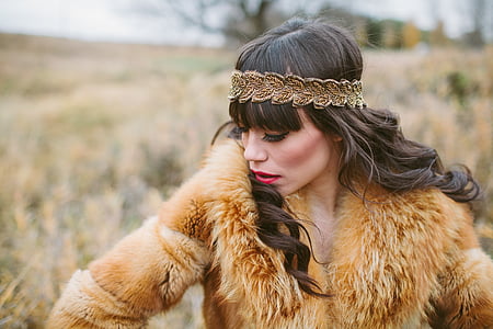 selective focus photography of woman in fur coat wearing headband