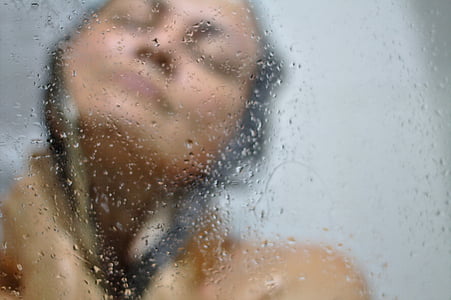 nude woman taking a bath near clear glass