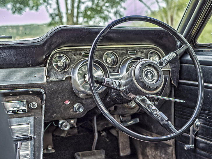 closeup photograph of steering wheel and car radio