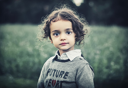 black haired child in gray sweater