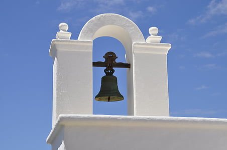 black steel bell on white concrete arc