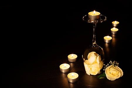 brass-colored candle stand and candles