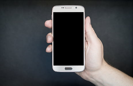 person holding white Android smartphone