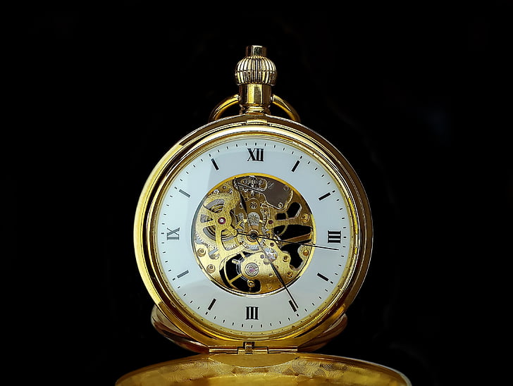 round white and gold-colored pocket watch reading at 11:24