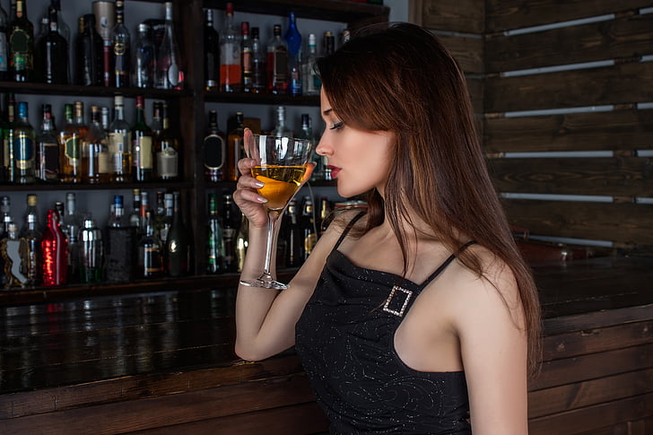 woman drinking wine inside bar