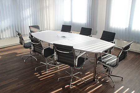white wooden table with eight armchairs