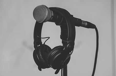 photo of headphones hanging on microphone