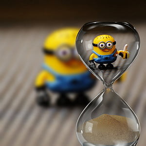 hourglass with minion action figure background