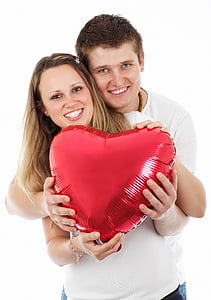 couple holding heart balloon