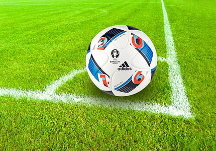 white Adidas soccer ball on field