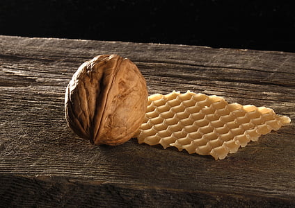 pecan nut and waffle on brown wooden surface
