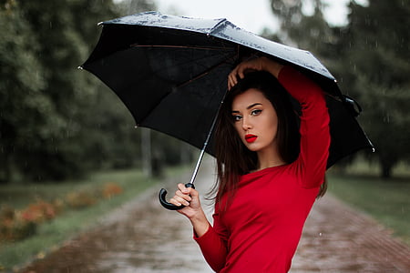shallow focus photography of woman wearing red long-sleeved shirt