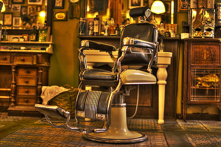 white and black leather barber chair on green floor mat