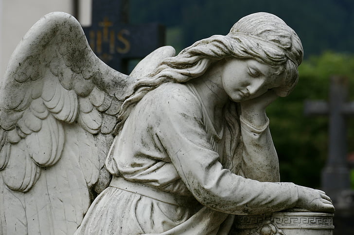 female angel leaning on column post