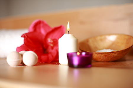 shallow photography of white candle on table