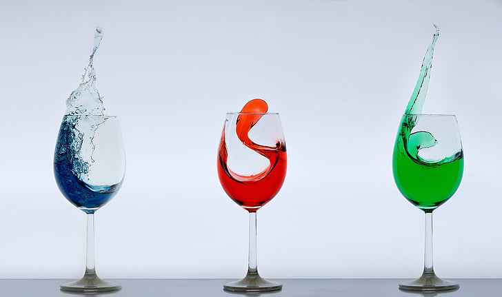three clear wine glasses with substance