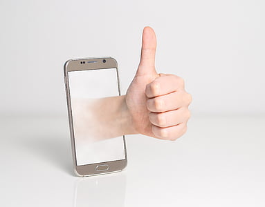 silver Android smartphone with left hand with white background
