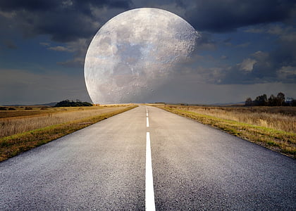roadway between grass field in front of moon digital wallpaper