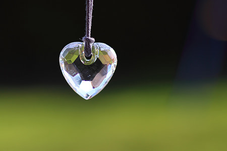 macro shot of clear gemstone heart pendant