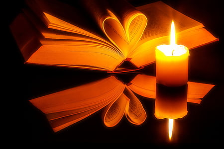 yellow candle beside of book