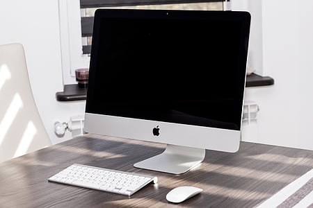 white iMac with Apple keyboard and magic mouse