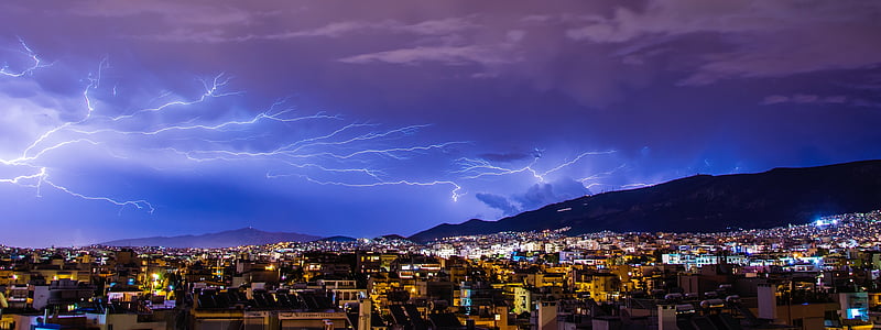 high-angle photograph of city under lightning