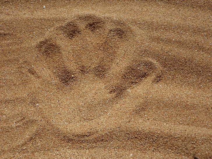 hand print on sand