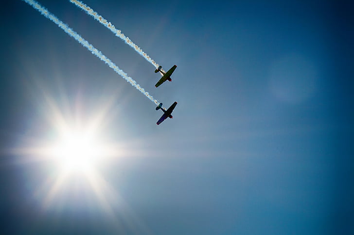 two plane silhouette flying on air