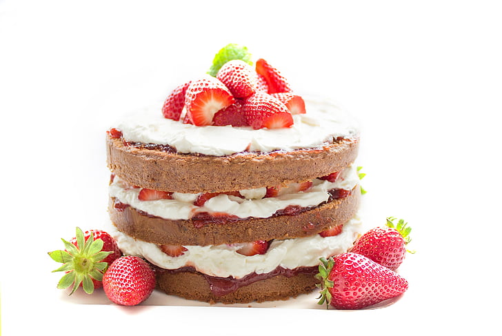 round strawberry and white whip cream topped cake