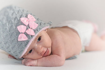 baby in gray and pink knit cap