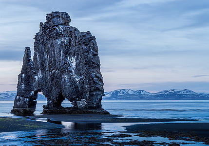gray rock on seashore landmark