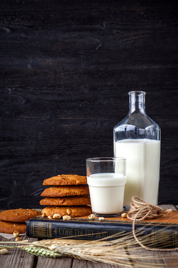 cookies near milk glass and bottle