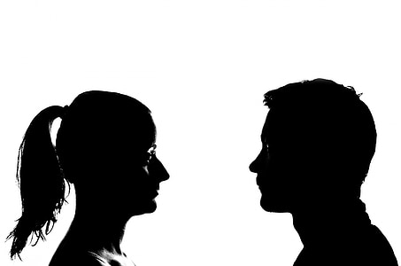 two silhouette of man facing woman